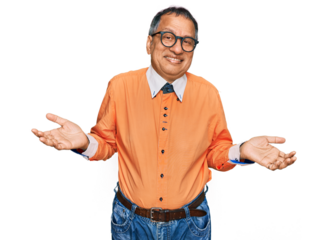 Middle age indian man wearing casual clothes and glasses clueless and confused expression with arms and hands raised. doubt concept.