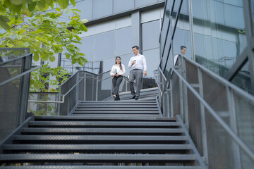 Business colleagues walking downstairs outdoors