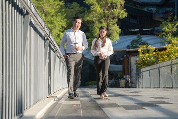Business colleagues walking in urban setting - 775233669