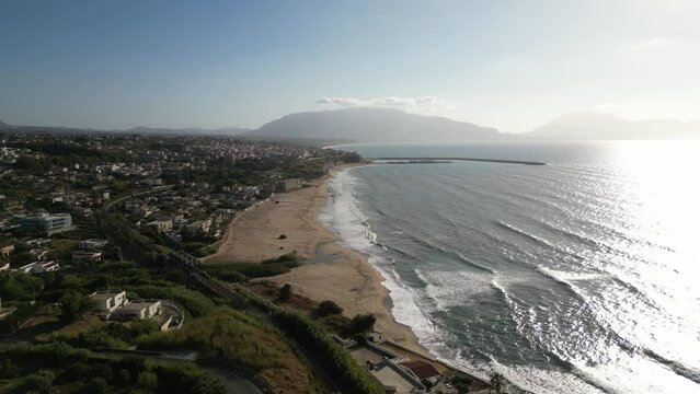 Drone shot of Balestrate with waves gently touching the sandy beach.