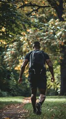 Obraz premium Young man wearing sport clothes doing rucking in the blooming park, back view