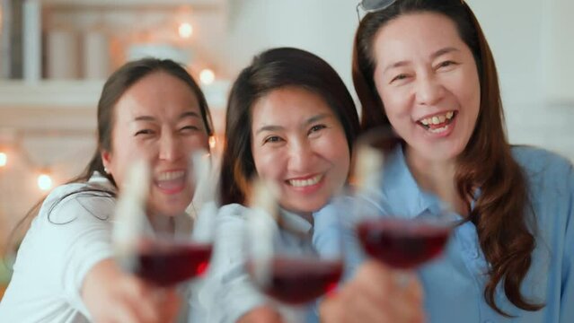 good old friend visit home asian mature woman friend talking standing in kitchen positive conversation good relation friendship reunion home visit casual relax hand hold wine glass goodvibe at home