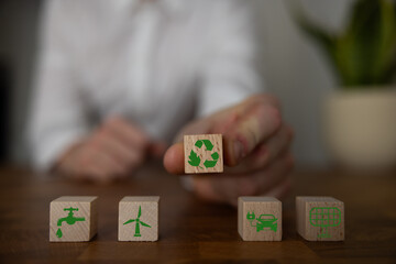 Green and eco building concept. wooden cubes with green building symbols on the natural background....