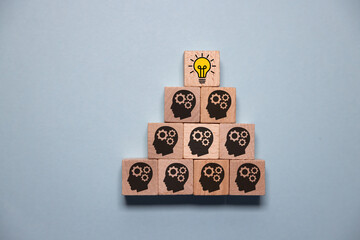 Concept creative idea and innovation. Hand picked wooden cube block with head human symbol and...