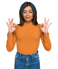 Young latin transsexual transgender woman wearing casual clothes relax and smiling with eyes closed doing meditation gesture with fingers. yoga concept.