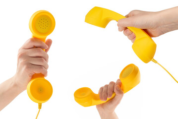 Yellow handset in woman hand isolated on white.