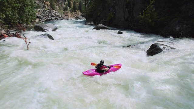 Extreme Sports Athlete Paddling Kayak into Dangerous Rapids