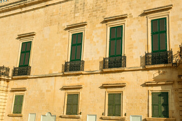 Obraz premium View of residential building with wooden shutters and balconies