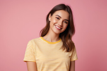 Fototapeta premium Portrait photo of attractive positive young girl wearing yellow striped t-shirt confident smile looking at you isolated on pink color background 