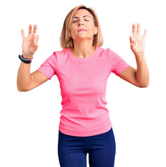 Young blonde woman wearing sportswear relaxed and smiling with eyes closed doing meditation gesture with fingers. yoga concept.