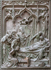 MILAN, ITALY - SEPTEMBER 16, 2024: The detail from main bronze gate of the Cathedral -   Nativity of St. John the Baptist -  by Ludovico Pogliaghi (1906).