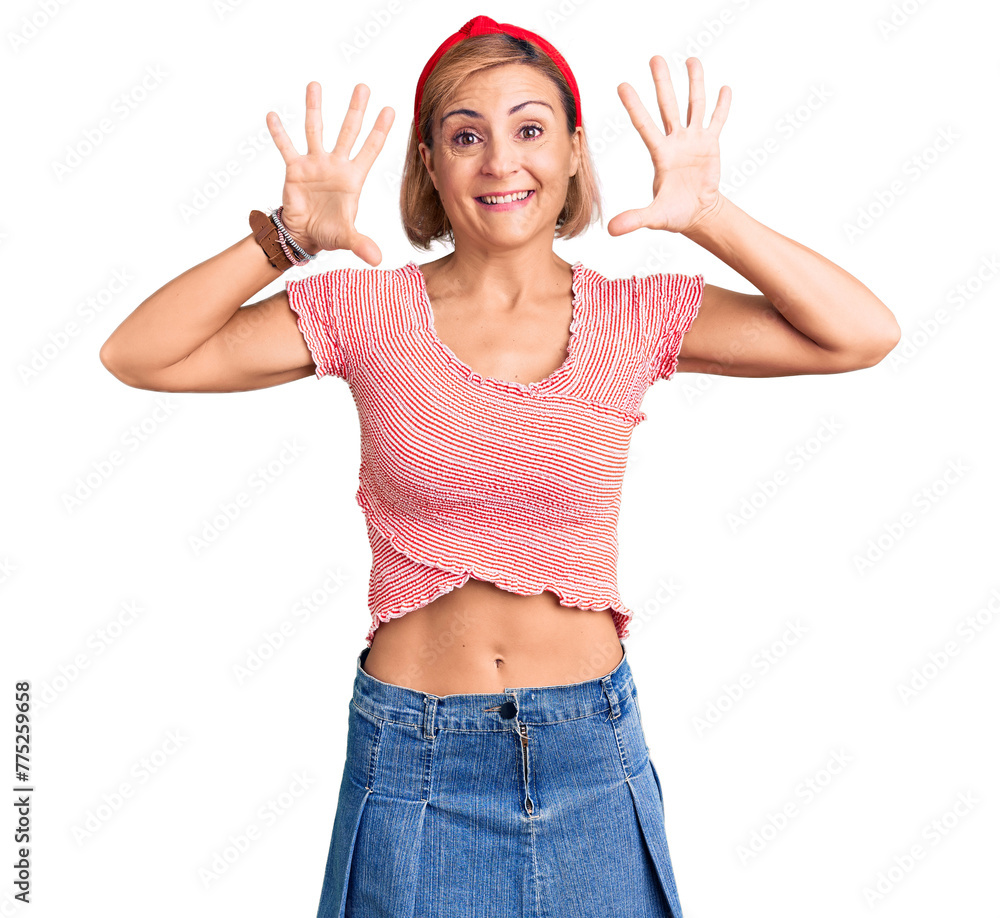 Wall mural Young blonde woman wearing casual clothes and diadem showing and pointing up with fingers number ten while smiling confident and happy.