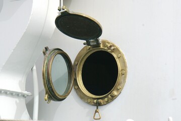 golden porthole on a ship © Aliaksandr