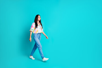 Fototapeta na wymiar Photo of nice cool cheerful cute woman dressed stylish clothes going looking empty space isolated on cyan color background