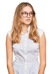 Beautiful young caucasian girl wearing casual clothes and glasses smiling looking to the side and staring away thinking.