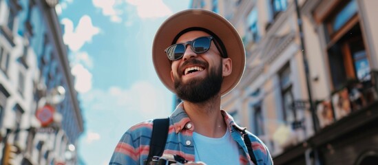 A man in hat and sunglasses holding camera - Powered by Adobe