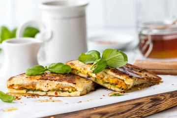 Delicious homemade naan bread breakfast sandwiches with honey and basil.