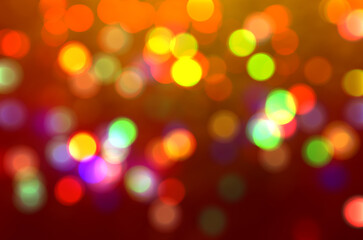 Obraz premium Orange defocused bokeh lights blur sparkling colorful background Gold lights Golden sparks glowing soft focus Luxury template New Year party Xmas Blurred texture Abstract motion template Christmas