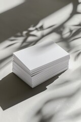 A stack of white cards on a table, suitable for various business or education concepts