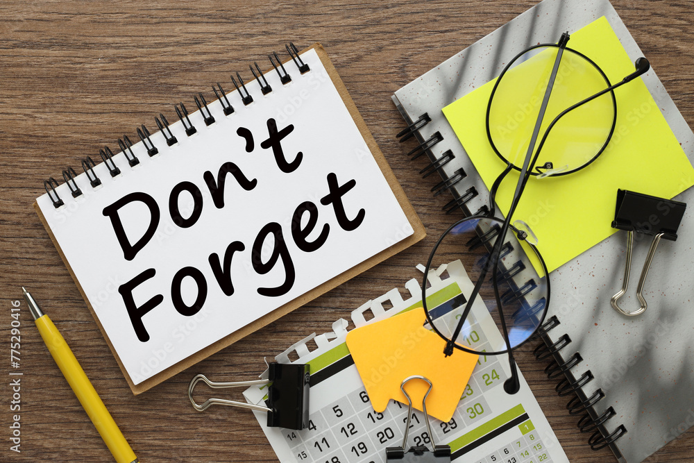 Poster do not forget small notepad with text on work desk