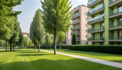 Fototapeten Modern residential buildings in a green area of the city. European apartment houses. Milan, Italy in the summer. And trees and grass in the walking area © Ai Creatives