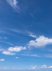 Sky with fluffy white clouds filling the blue expanse.