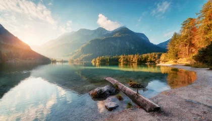 Zelfklevend Fotobehang incredible autumn scene of hintersee lake sunny morning view of bavarian alps on the austrian border germany europe beauty of nature concept background orton effect © joesph