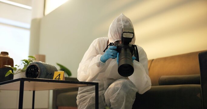 Csi, photographer and forensic at crime scene for investigation of house burglary or murder analysis. Evidence, person and digital pictures in hazmat for observation, examination and case research