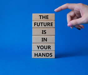 The Future is in your Hands symbol. Concept words The Future is in your Hands on wooden blocks. Beautiful blue background. Businessman hand. Business concept. Copy space.