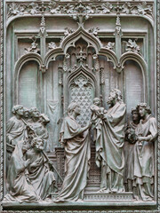 MILAN, ITALY - SEPTEMBER 16, 2024: The detail from main bronze gate of the Cathedral -   Presentation of Jesus in the temple -  by Ludovico Pogliaghi (1906). - 775311050