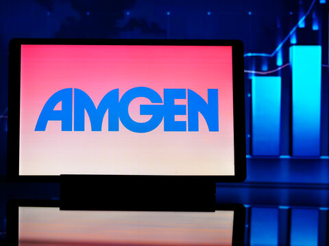 In this photo illustration,  Amgen Inc. (formerly Applied Molecular Genetics Inc.)  logo seen displayed on a tablet