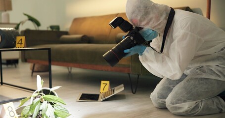 Csi, photographer and evidence at crime scene for investigation of house burglary or murder analysis. Forensic, person and digital pictures in hazmat for observation, examination and case research - obrazy, fototapety, plakaty