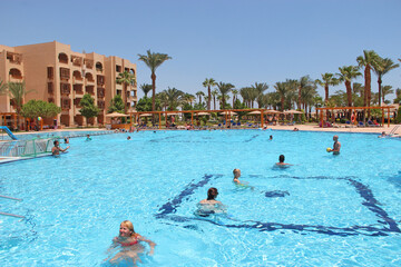People swimming in pool of tropical resort. swimming pool with transparent water