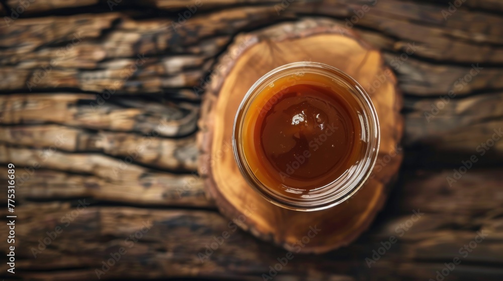 Poster a jar of liquid sitting on a wooden table. suitable for various concepts and designs