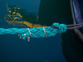Knots on a tense mooring line. Fastening the ship to the shore. Tight rope.