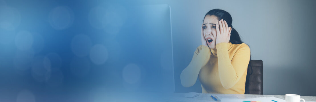 sad woman with computer and graph in office