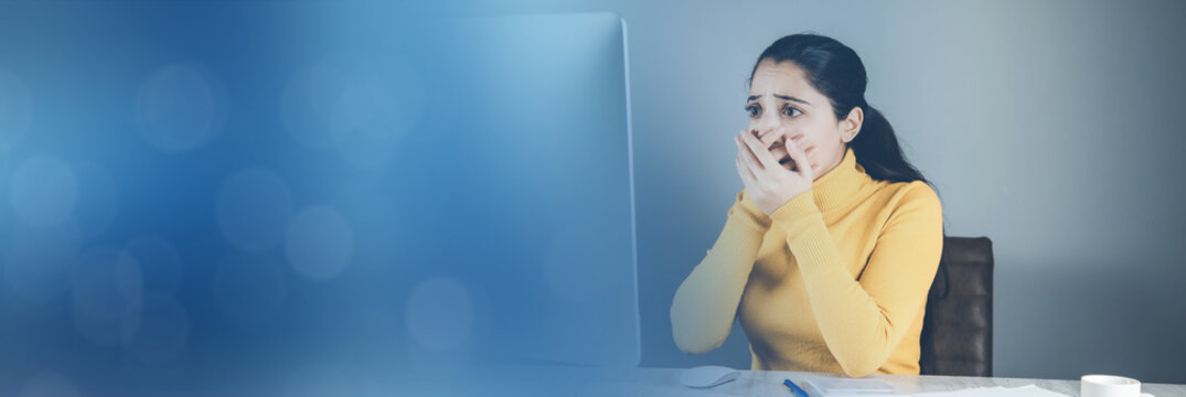 sad woman with computer and graph in office