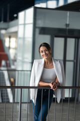Fototapeta premium Elegant mature woman standing near the banister