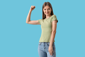 Strong young woman with applied medical patch on color background