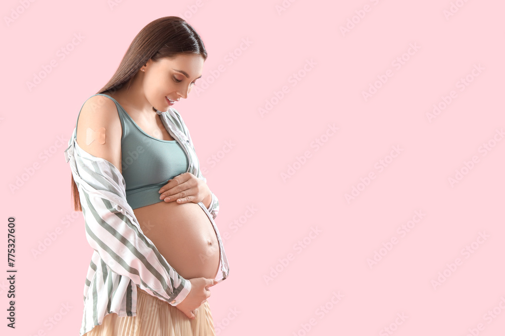 Poster Young pregnant woman with medical patch after vaccination on pink background