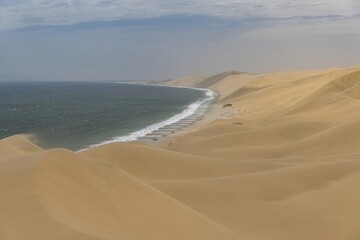 Fototapeta na wymiar Picture of the dunes of Sandwich Harbor in Namibia on the Atlantic coast during the day