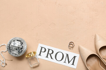 Word PROM with female shoes, disco ball and perfume bottle on beige grunge background