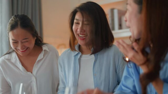 woman old friend dancing while hear favorite song good old memory reunion party in kitchen at home,laugh smile happiness asian woman friend enjoy dance and jump with fun together while listening song