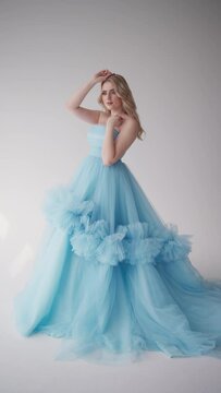 Gentle woman in blue tulle dress. Concept Ethereal beauty, exquisite tranquility, calm elegance