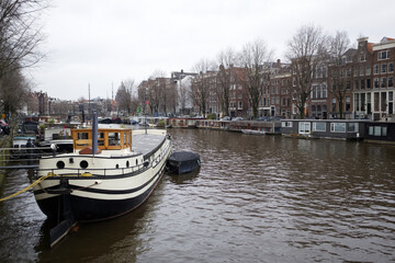 View of a river canal and a boat in the historical center of Amsterdam 10.02.2024