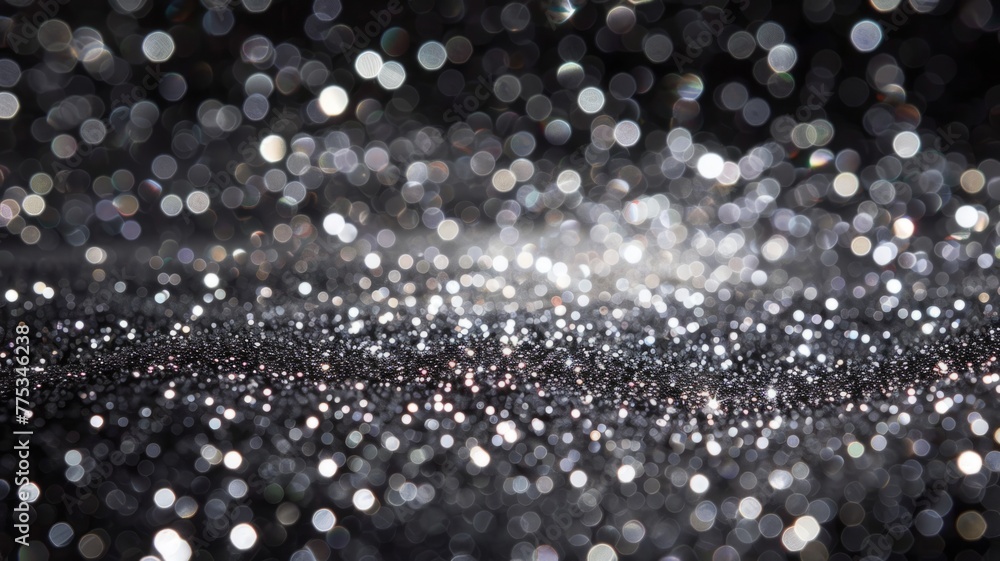 Poster bokeh effect with silver glitters on black - sparkling silver glitters dominate this bokeh effect im