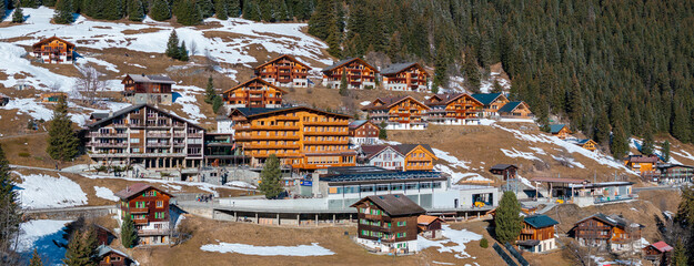 Aerial panoramic view of the Verbier ski resort town in Switzerland. Classic wooden chalet houses...