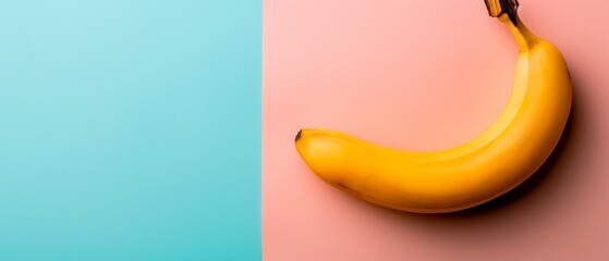   A yellow banana sits on a pink and blue wall beside two pink and blue walls