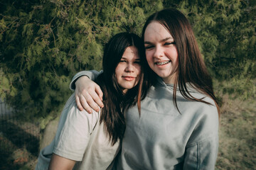 Obraz premium Young girls pose for the camera. Emotional girls were happy to meet