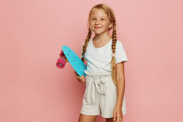 Childhood Joy: Adorable Girl Skateboarding on a Stylish Penny Board in a Casual and Active Lifestyle
